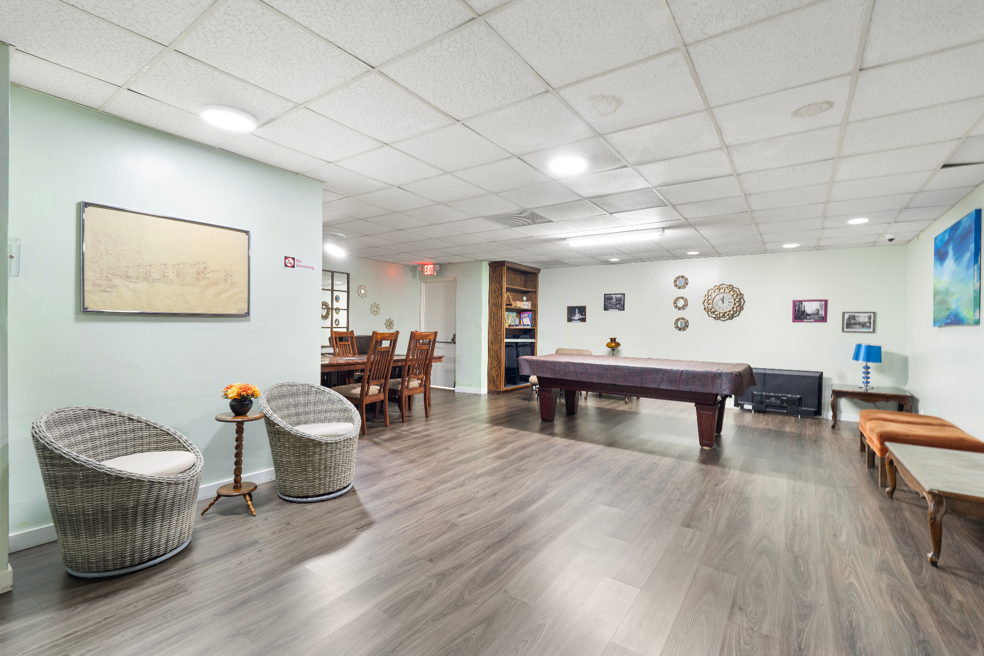 Spacious community room with pool table, dining seating, and lounge area for events